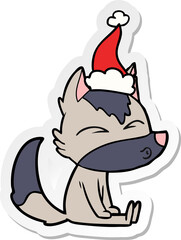 hand drawn sticker cartoon of a wolf whistling wearing santa hat