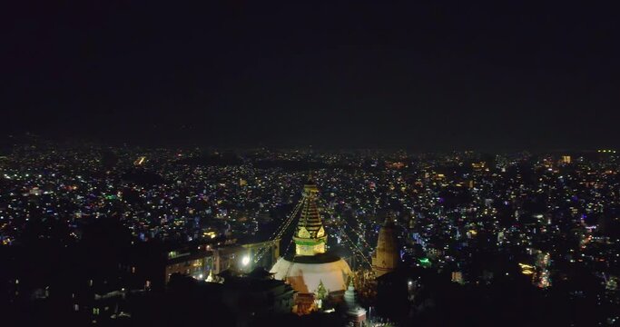 The drone orbits around Swayambhunath Stupa, known as Monkey Temple, showcasing the beauty of Kathmandu at night during Tihar Light festival. A mesmerizing aerial view capturing the essence of Nepal.