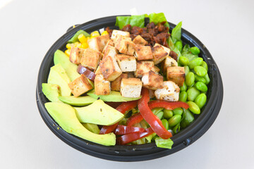 Green salad with arugula, lamb and tomatoes. Healthy vegan dish. Top view at table. Turkish Coban (choban) salata or Shepherds salad, Akdeniz salad in white bowl.