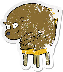 distressed sticker of a cartoon bear sitting on chair