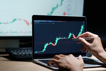 trader working in modern office, looking at display, sale and buy and analyzing index on market diagram.