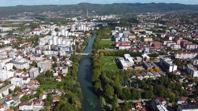 Aerial drone view of Banja Luka, Bosnia and Herzegovina. River Vrbas, buildings, streets, parks and residential houses. City center of Banja Luka, view from above. 