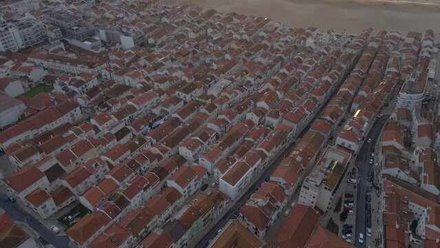 Areal Drone Footage of the Town of Nazare on the Coast of Portugal Filmed During Sunset Golden Hour 4K