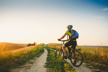 Fototapeta na wymiar Mountain Bike cyclist on a sunny day. Healthy Lifestyle and Travel Concept