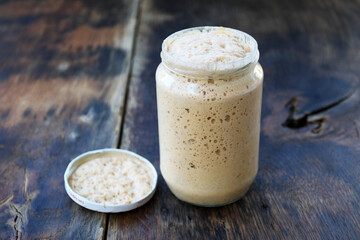 Sourdough bread Dough is active. Beginning Maya. The concept of a healthy diet. On a wooden and in a jar 
