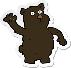 sticker of a cartoon waving black bear