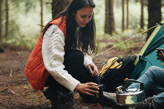 Woman making coffee while camping