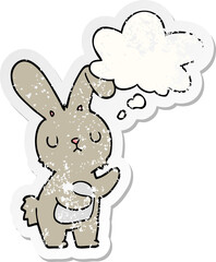 cute cartoon rabbit with thought bubble as a distressed worn sticker