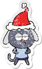 hand drawn distressed sticker cartoon of a bored dog wearing santa hat