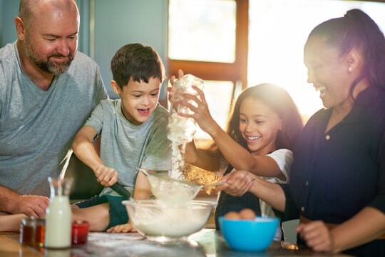 Happy family baking together in kitchen at home - Powered by Adobe