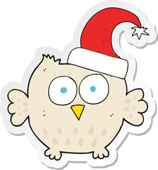 sticker of a cartoon little owl wearing christmas hat