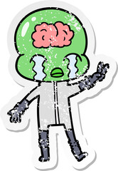 distressed sticker of a cartoon big brain alien crying and giving peace sign