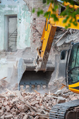 Demolition of building. Excavator breaks old house. Freeing up space for construction of new...
