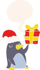 cartoon penguin with christmas present with speech bubble in retro style