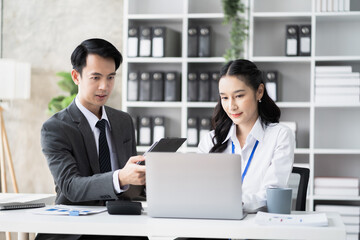 Obraz premium Businessmen team or financial data analysts working with tablets and laptop computers and data graphs together. Plan to analyzing projects in the office.