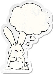 cartoon rabbit with thought bubble as a distressed worn sticker