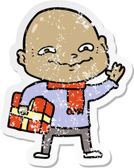 distressed sticker of a cartoon nervous man with xmas present