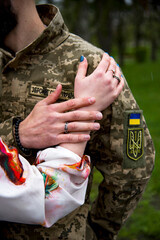 hands of ukrainian military man and  woman with ring