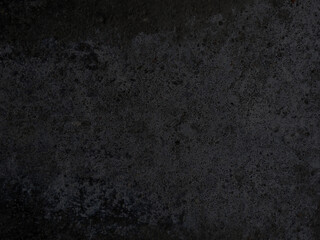Grunge concrete wall in black tones. Rough surface with irregular abstract pattern. 