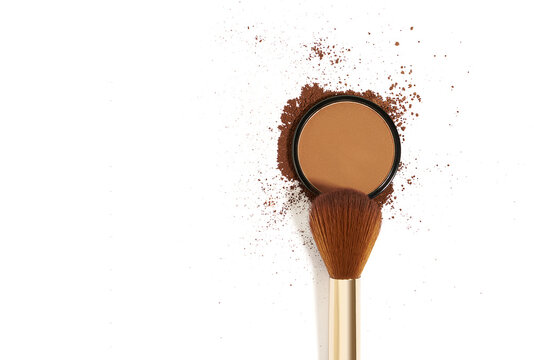 Close up of crushed bronzing powder with makeup brush isolated on white background. Bronzer for face contouring or creating tanned look