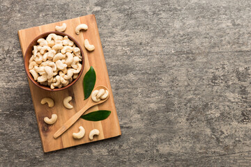 cashew nuts in wooden bowl on table background. top view. Space for text Healthy food