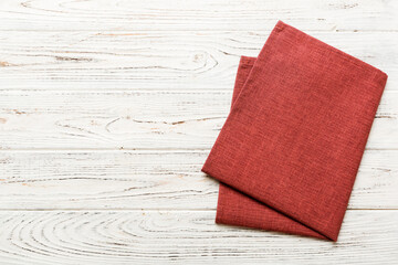 top view with red empty kitchen napkin isolated on table background. Folded cloth for mockup with...