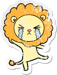 distressed sticker of a cartoon crying lion