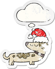 cartoon dog wearing christmas hat with thought bubble as a distressed worn sticker