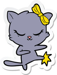 sticker of a cute cartoon cat with bow