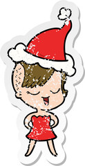 happy hand drawn distressed sticker cartoon of a girl in cocktail dress wearing santa hat
