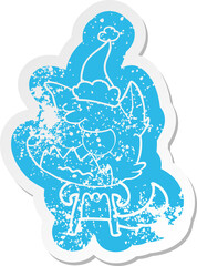 quirky cartoon distressed sticker of a annoyed fox wearing santa hat