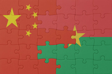 puzzle with the national flag of burkina faso and china . macro.concept.