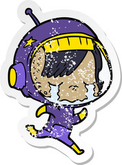 distressed sticker of a cartoon crying astronaut girl