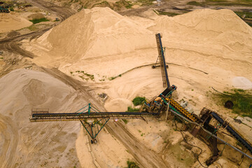 Fototapeta na wymiar Conveyor and production of construction sand. Quarry and mineral extraction plant. Extractive industry