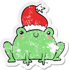 distressed sticker of a cute cartoon christmas frog
