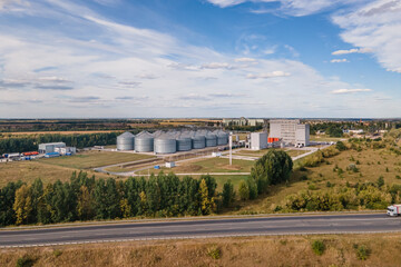 Fototapeta na wymiar Grain silo elevator grain storage tanks in industrial zone for grain processing silos for agribusiness