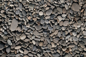 Ocean waves breaking against rocky pebble stone shoreline marine landscape close-up. Suitable for articles, backgrounds, design projects