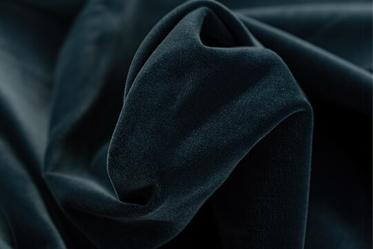 Dark blue velur fabric. A noble marine shade with rich drape and a smooth texture with a beautiful matte sheen. background texture, pattern.