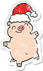 distressed sticker of a cartoon happy christmas pig