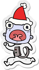 hand drawn sticker cartoon of a weird alien running away wearing santa hat