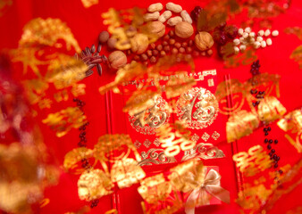 Nuts and red envelopes on a red tabletop, bokeh foreground, festive pictures of oriental countries, pictures of weddings and happy events(Translation: "Fu" is a symbol of auspiciousness)