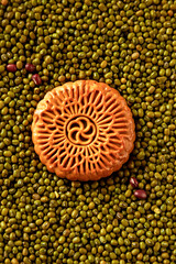 Mooncakes with red and mung bean fillings, on a wooden tabletop, popular food for Chinese Dragon Boat Festival