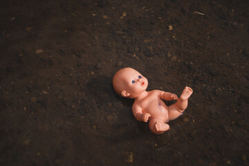 Damaged doll floating in creek