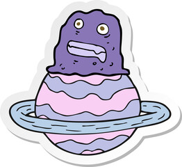 sticker of a cartoon alien on planet