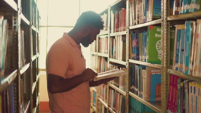The video showcases a Nepali boy around 23, reading a book at the library of the University. His focused demeanor and the peaceful environment of the library create a serene and studious atmosphere.