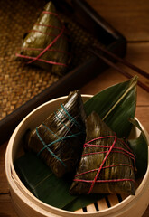 zongzi, rice dumplings,Made with glutinous rice and meat or egg yolk, wrapped in zong leaves