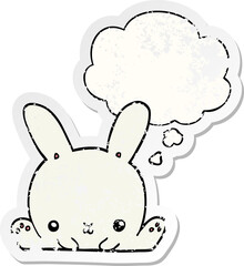 cartoon rabbit with thought bubble as a distressed worn sticker