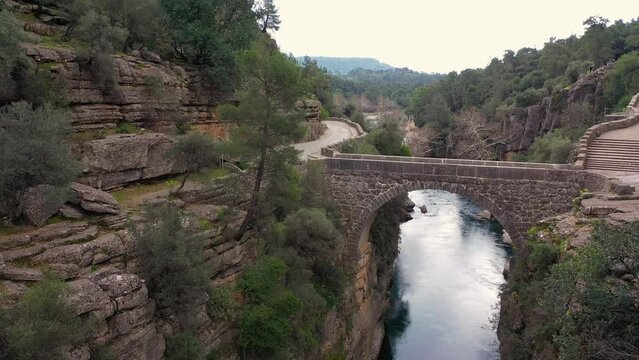 Old stone bridge in Koprulu canyon over K&ouml;pr&uuml;&ccedil;ay river, drone video, aerial view. Antalya, Turkey