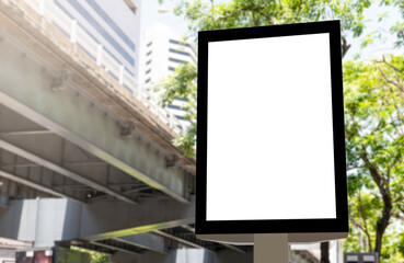 Outdoor pole vertical light box billboard with mock up white screen on footpath and clipping path