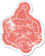 quirky cartoon distressed sticker of a dog face wearing santa hat